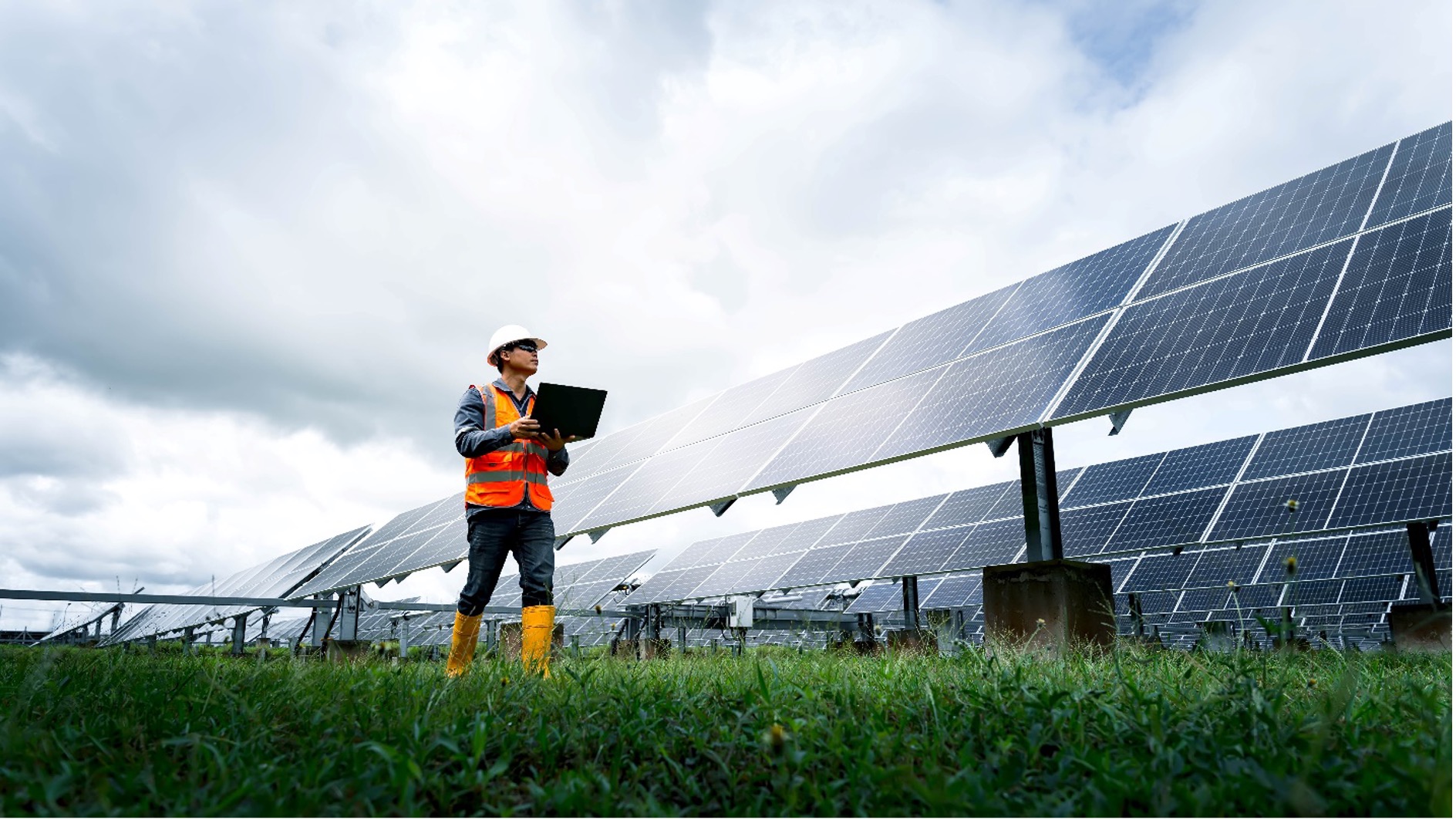 operator with a laptop at a solar installation